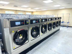 Modern, clean laundromat with high-tech machines.
